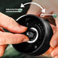 Black electric grinder base with hands adjusting the fineness dial