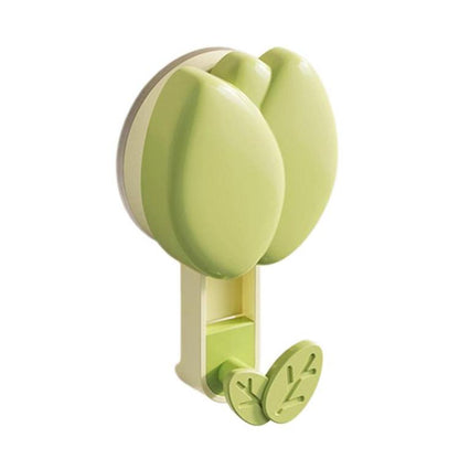 Green flower-shaped suction cup towel rack with two leaf hooks and storage base