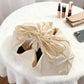 Mini bag organizer insert pouch in apricot-beige, drawstring closure tied at the top