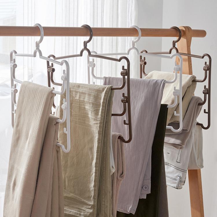 White multi-layer pants hanger rack with clips, holding folded trousers