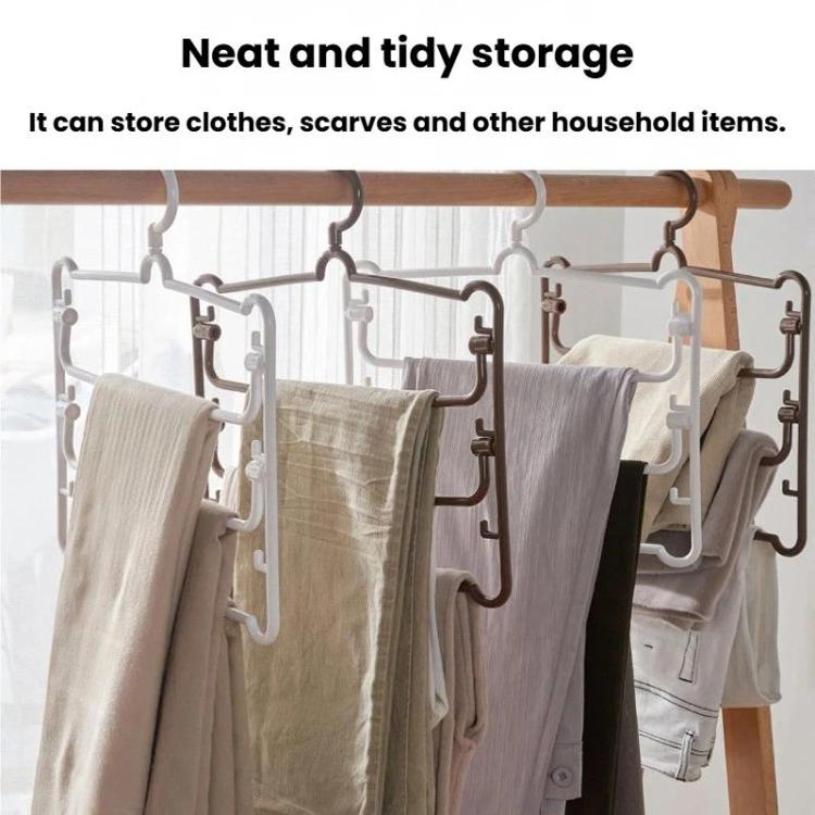 White multi-layer pants hanger rack with clips, displaying folded pants
