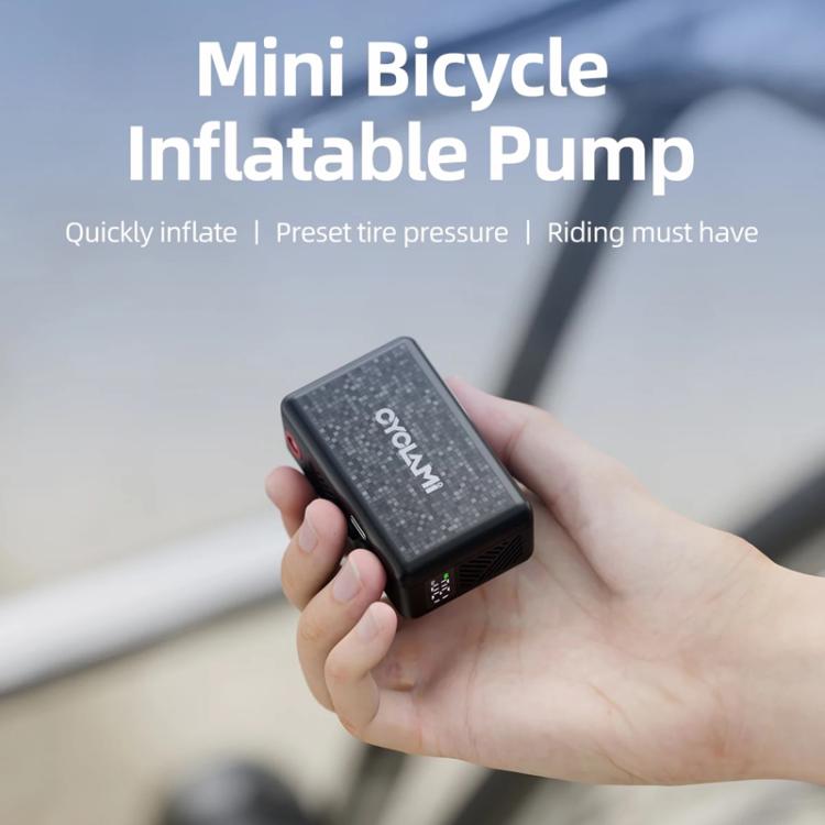 Mini electric air pump held in a hand, compact black body with red power button