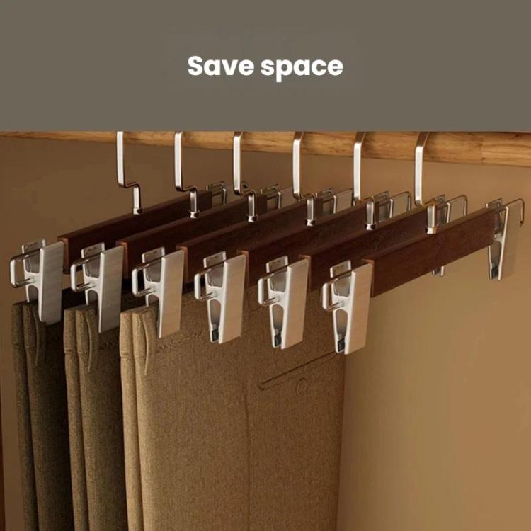 Wooden pants hangers on rod with multiple black clamp clips