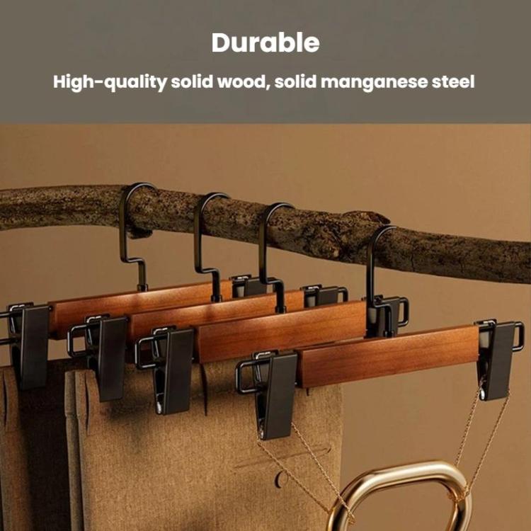 Brown wooden pants hanger set with black clamps and curved hanging hooks on rod