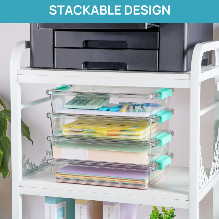 Clear stackable storage boxes with teal latch lids on a white shelf