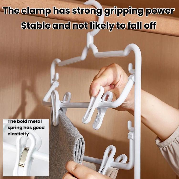 White plastic 3-tier pants hanger with clips being clamped by a hand
