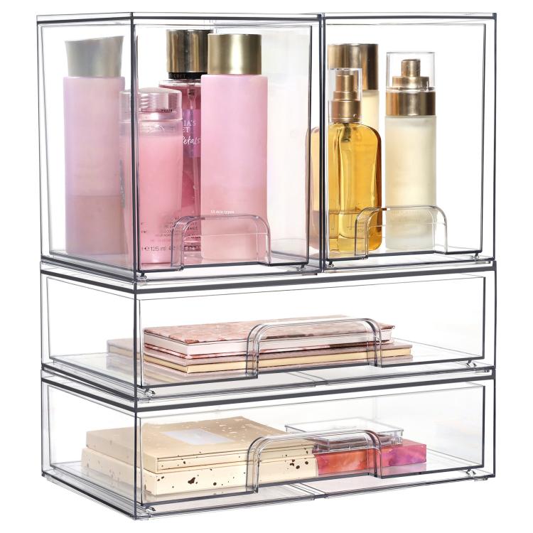 Transparent three-tier cosmetic organizer with open bins holding skincare bottles, creams, and a tray