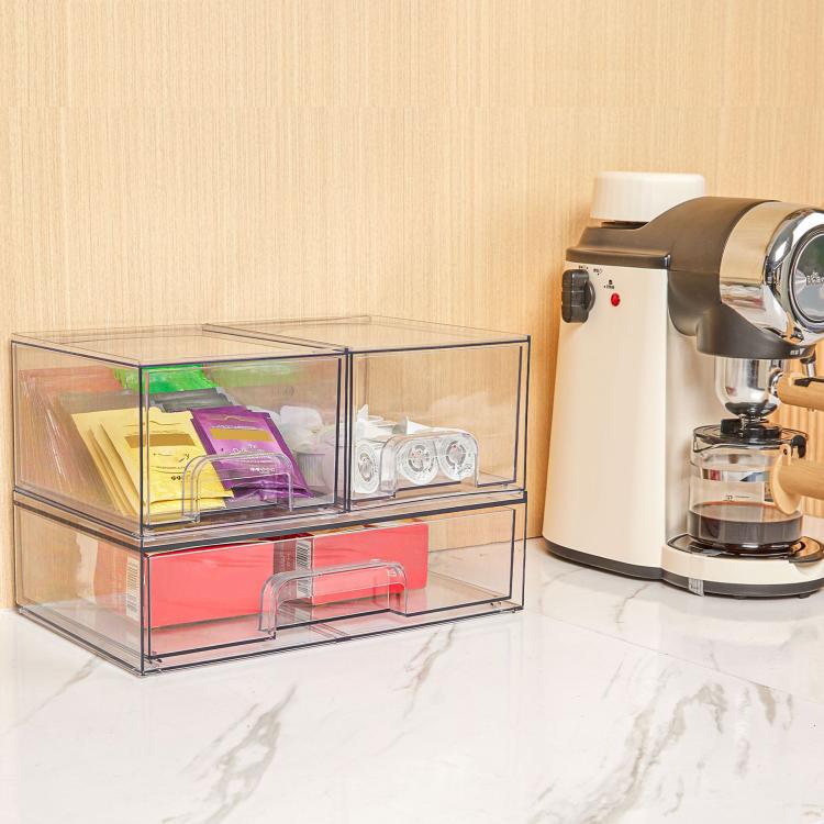 Transparent plastic cosmetic organizer box with open drawers for makeup and small accessories