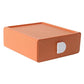 Orange plastic drawer organizer with diamond-textured sides and white handle cutout