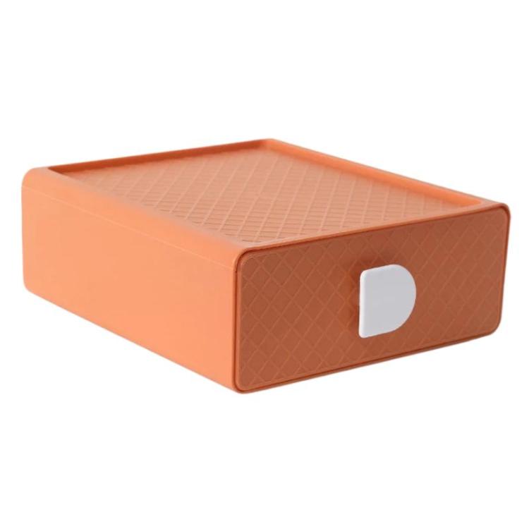 Orange plastic drawer organizer with diamond-textured sides and white handle cutout