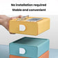 Yellow plastic drawer organizer with white handle cutout and matching teal drawer below