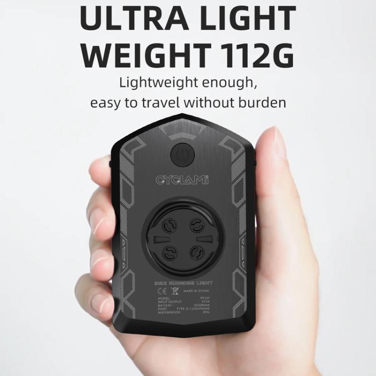 Black cycling warning light held in hand with control button panel