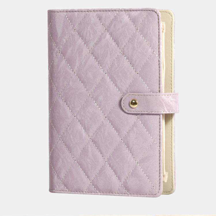 Lavender quilted jewelry organizer book with snap strap and cream interior backing.