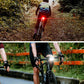 Bicycle with front white headlight and rear red taillight lit while riding
