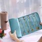 Turquoise roll-up jewelry organizer bag open flat with elastic loops and necklace slots