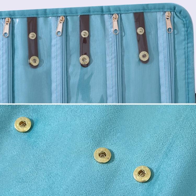 Close-up of light blue organizer pockets with gold-tone snap buttons and zipper sliders