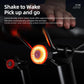 Bicycle rear light with amber glow and red lens mounted on handlebars