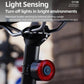 Bicycle rear light with red lens mounted under the handlebars