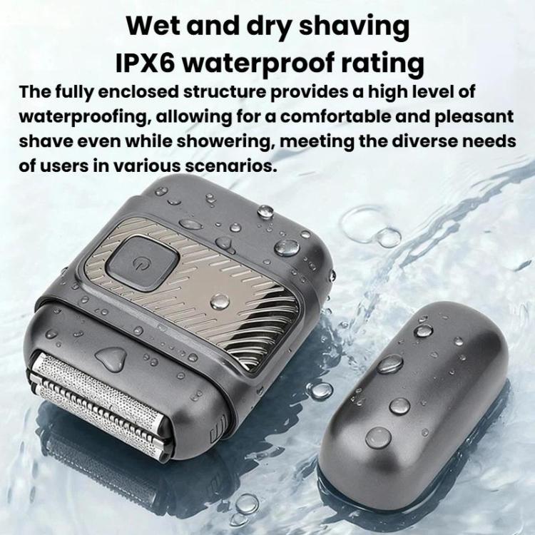 Gray electric shaver with foil head, shown wet with water droplets