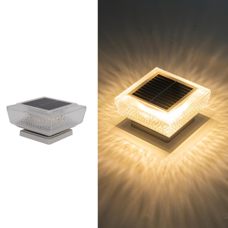 Solar LED pillar light glowing warm, square top with dark solar panel
