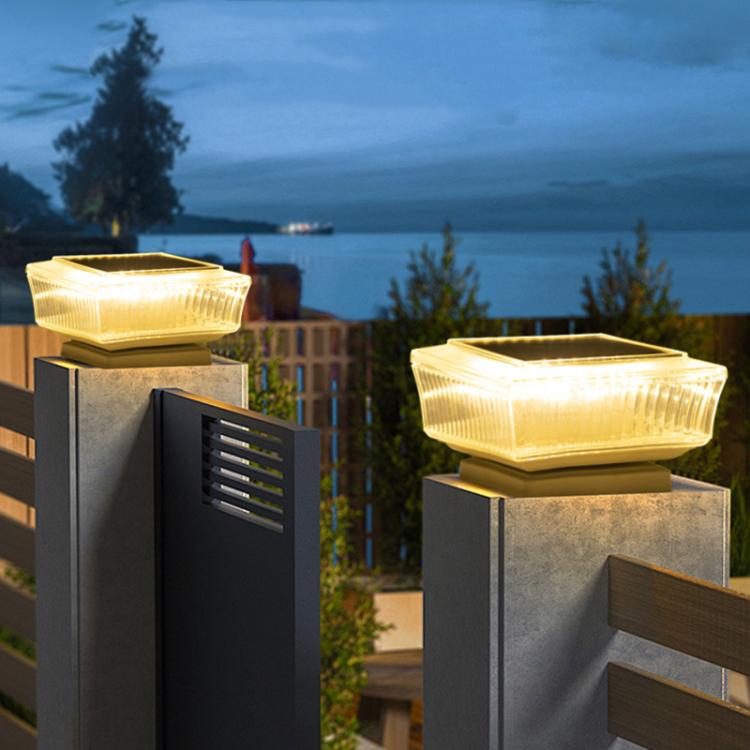 Two solar LED pillar lights with warm glow mounted on square outdoor posts