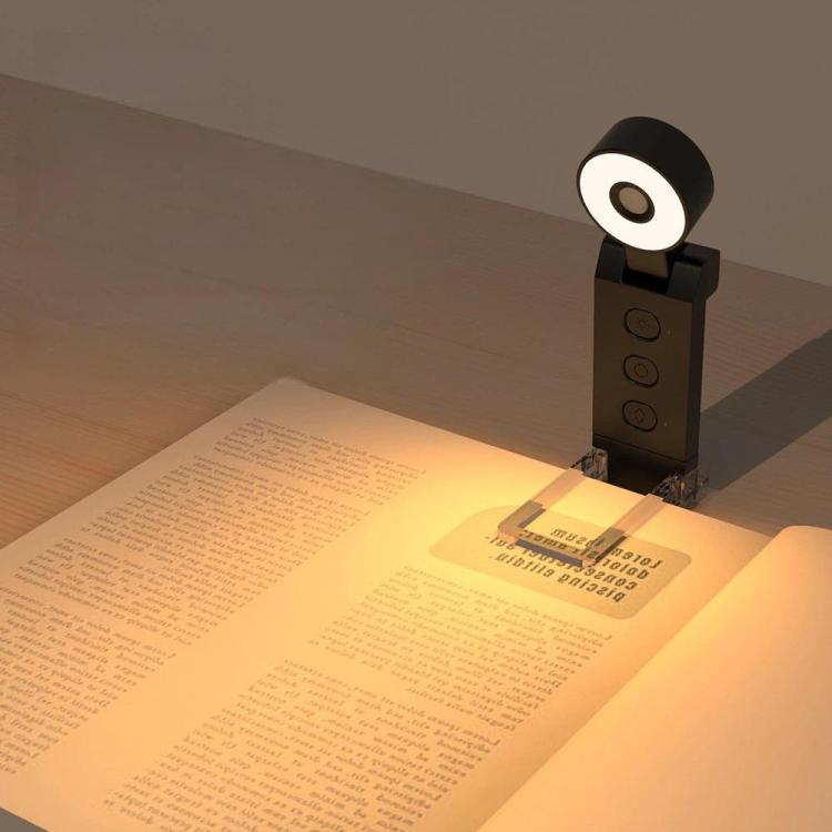 Mini USB clip-on LED bookmark lamp projecting light, black round head on clip stand.