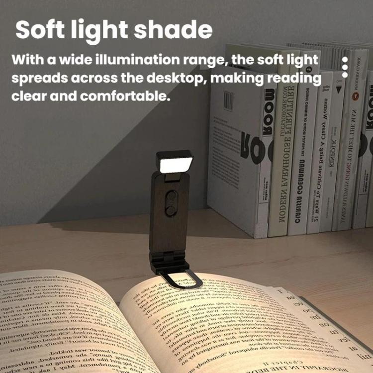 Black clip-on LED mini bookmark lamp lighting an open book