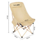 Tall beige folding camping moon chair with padded armrests and leg support