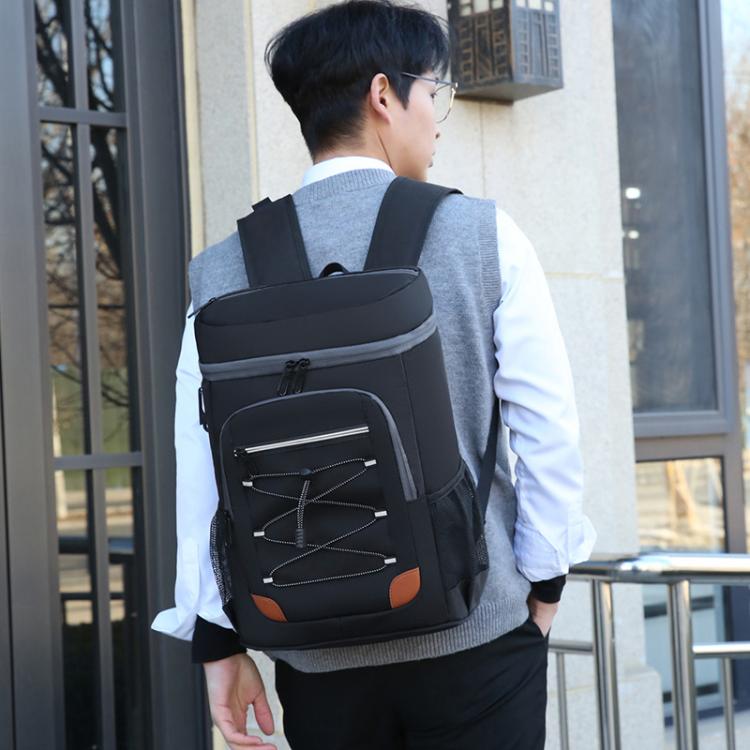 Black insulated backpack cooler with front zip pockets and orange accent panel