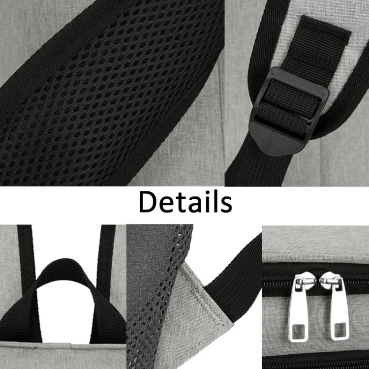 Gray backpack close-up of mesh strap padding and dual metal zipper pulls.