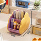 Yellow cosmetic storage rack with open front holds makeup tubes and small cartoon figurines
