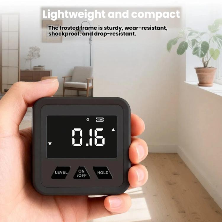 Magnetic digital inclinometer held in hand, LCD reads 0.16, black body, DM318