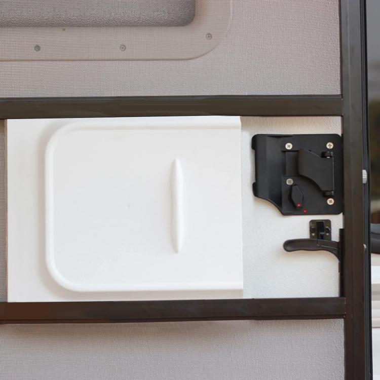 Black RV door lock UV cover and handle mounted on an RV screen door