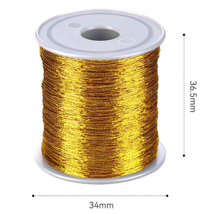 Gold fishing rod tying line spool with open center on the spool