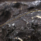 Thin fishing guide tying line on dark rocky surface