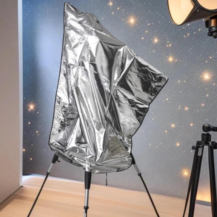 Silver telescope cover with tripod legs shown in front view