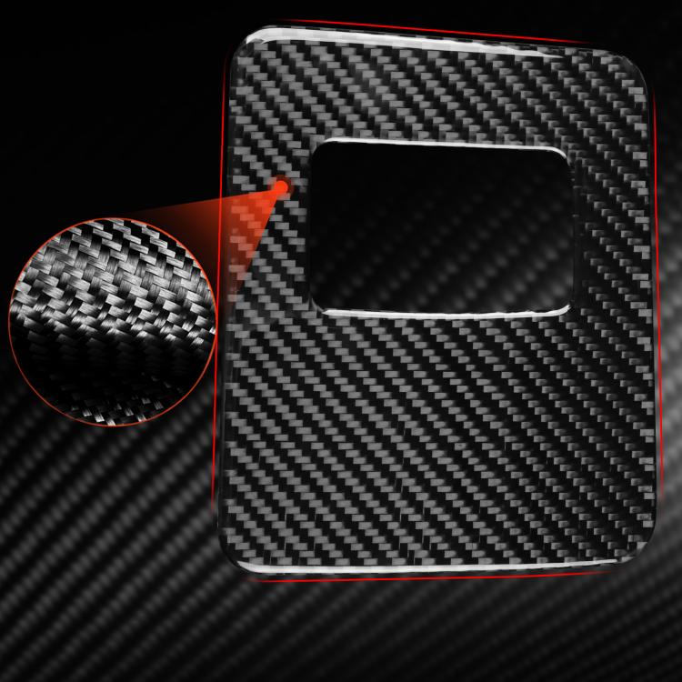 Black carbon-fiber glove box sticker with rectangular cutout, close-up view
