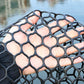 Close-up of black hexagonal mesh netting with elastic net structure