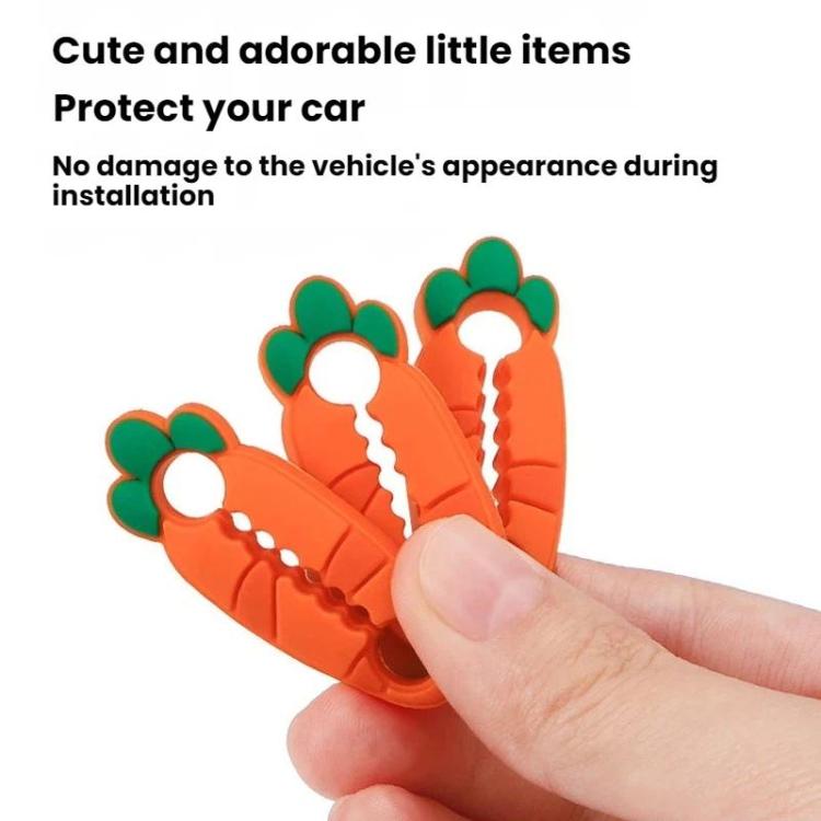 Orange silicone car latch cover clips with green bumpers, held in a hand