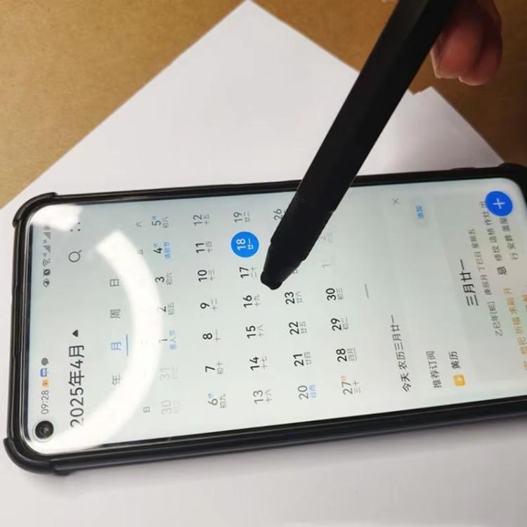 Multifunctional stylus tool pen tapping a smartphone screen with the pen tip