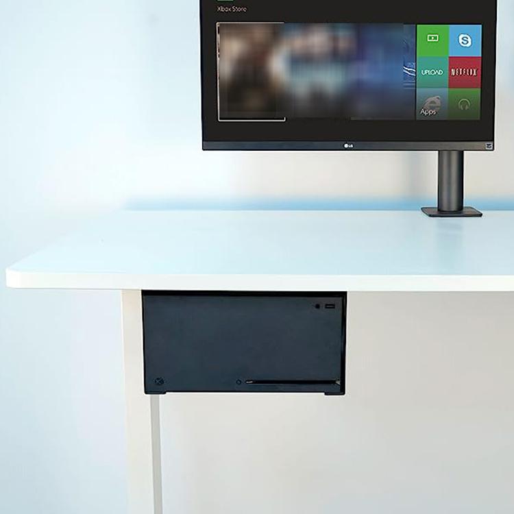 Under-desk console holder mounted under a desk, showing the front access opening