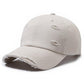 Distressed light beige ripped baseball cap with frayed brim and stitched front patches