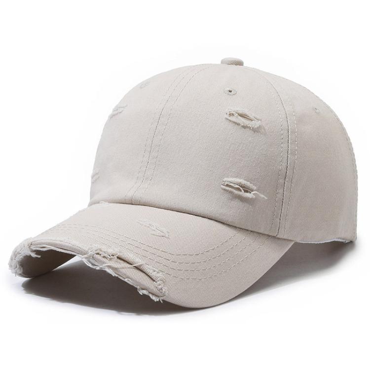 Distressed light beige ripped baseball cap with frayed brim and stitched front patches