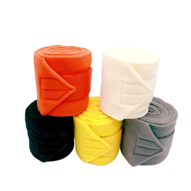Assorted set of 4 thick fleece horse leg wraps: orange, white, black, and gray.