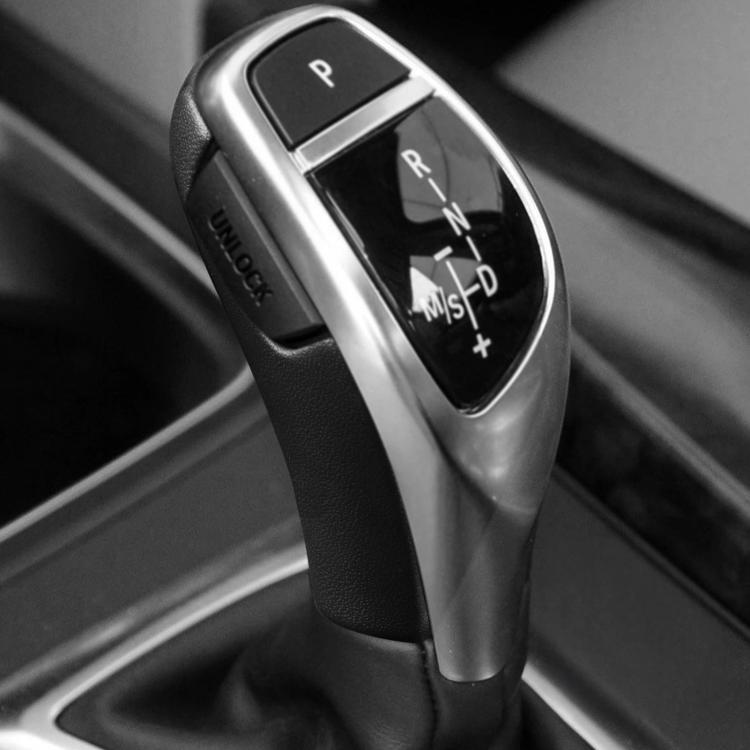 Black gear shift knob cover surrounding the shift selector panel