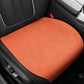 Car seat cushion in orange fabric with laser-perforation pattern and stitched border