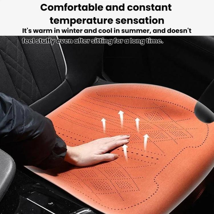 Orange car seat cushion with perforated top, shown being pressed by a hand