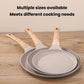 Set of beige non-stick frying pans with wooden handles, stacked in different sizes.