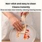 Beige nonstick frying pan being wiped clean with a paper towel