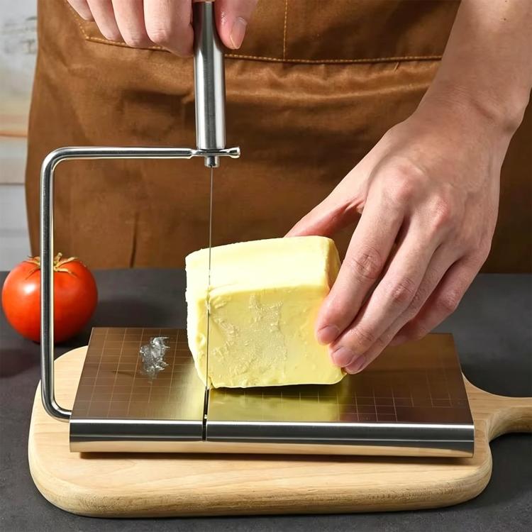Stainless steel cheese slicer cutting a cheese block with guide wire